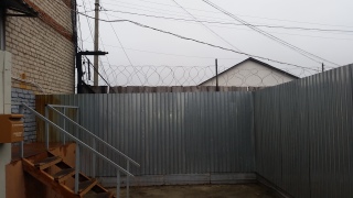 Fences and barbed wire surrounding the visitors entrance to the Sadovaya Colony. (Photo: Charles Digges)